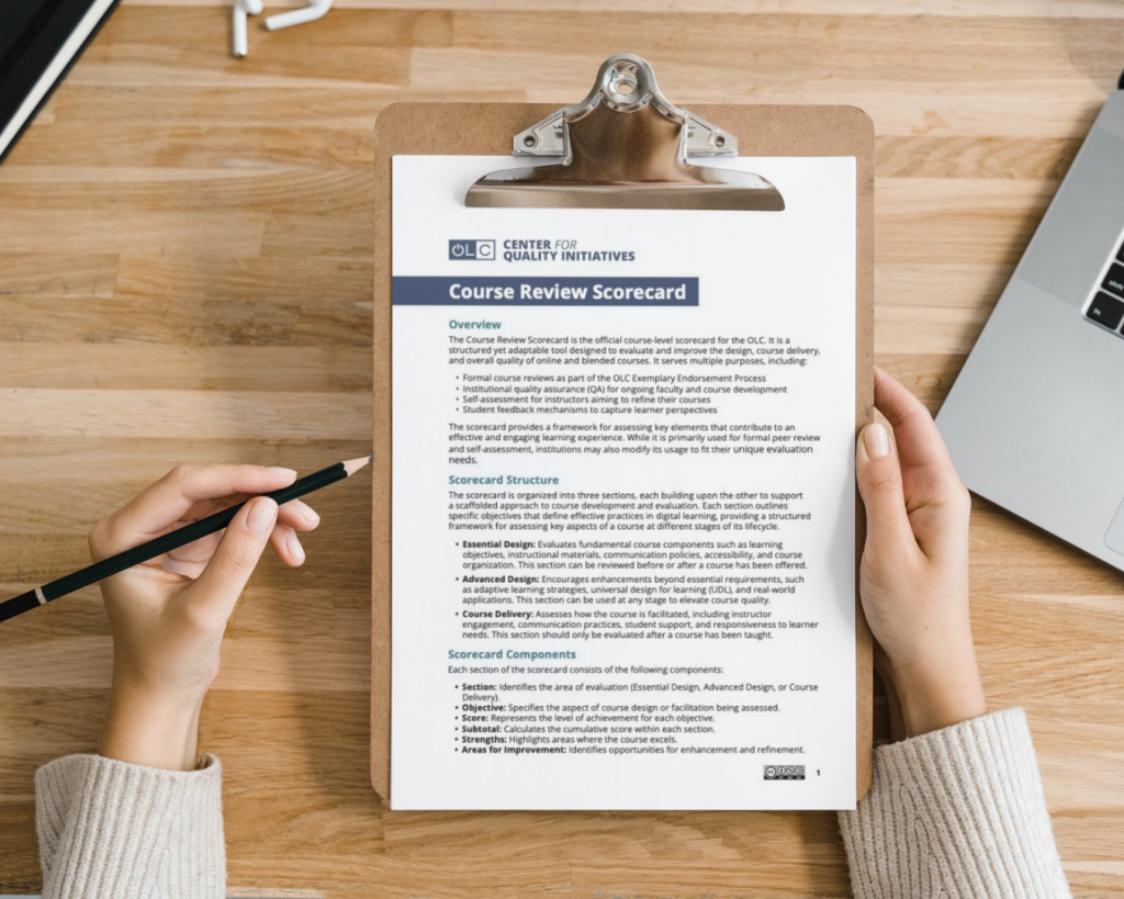 A top-down image of a woman holding a clipboard over a desk. The front page of the Course Review Scorecard is attached to the clipboard, and the woman holds a pencil over the page.